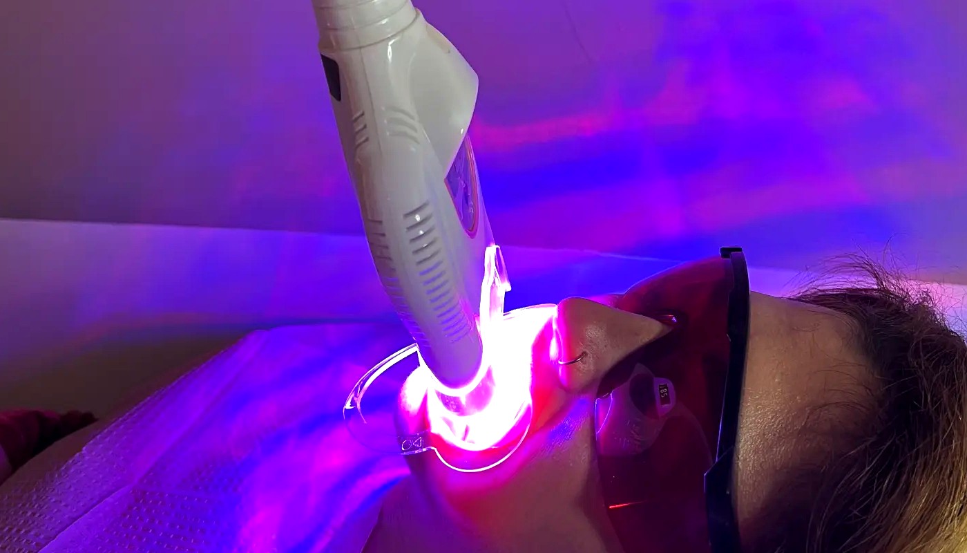 Client receiving laser teeth whitening treatment at Desert Rose Retreat in Prescott AZ